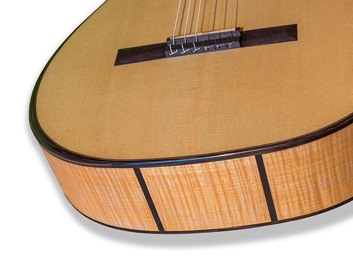 Flamed maple back and sides with a spruce/cedar doubletop and ebony bindings