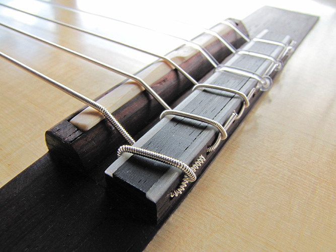 12-hole bridge.  Note the intonated saddle and the break angle of the strings.